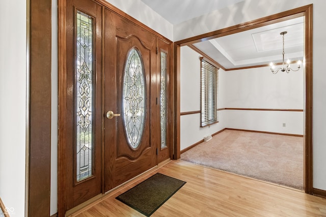 8439 Goldfinch Cir, Indianapolis, IN 46256 - foyer with a chandelier, light wood finished floors, and light colored carpet