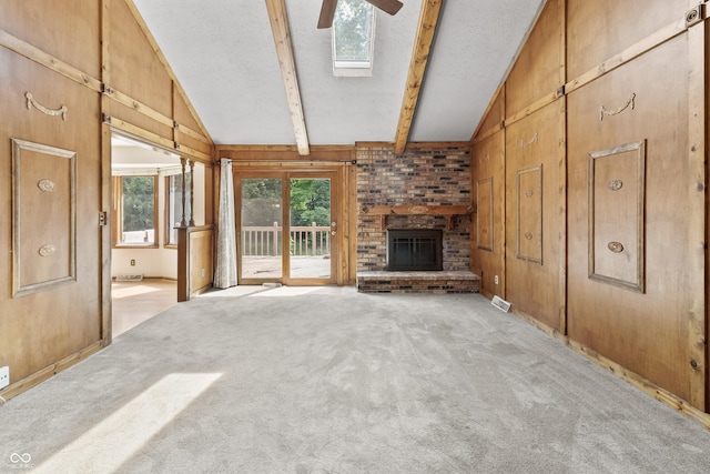 8439 Goldfinch Cir, Indianapolis, IN 46256 - unfurnished living room featuring ceiling fan, a textured ceiling, a fireplace, light carpet, and wood walls