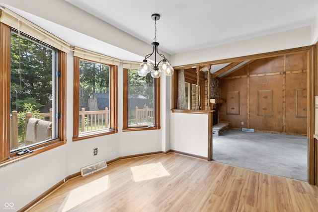 8439 Goldfinch Cir, Indianapolis, IN 46256 - unfurnished dining area featuring a chandelier, light wood-style flooring, and stairway