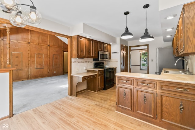 8439 Goldfinch Cir, Indianapolis, IN 46256 - kitchen with black range with electric stovetop, stainless steel microwave, tasteful backsplash, a chandelier, and light countertops