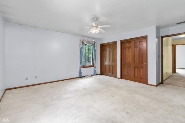 8439 Goldfinch Cir, Indianapolis, IN 46256 - unfurnished bedroom with multiple closets, carpet floors, and a ceiling fan