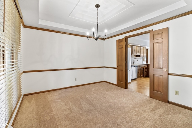8439 Goldfinch Cir, Indianapolis, IN 46256 - spare room featuring a raised ceiling, light colored carpet, and a chandelier
