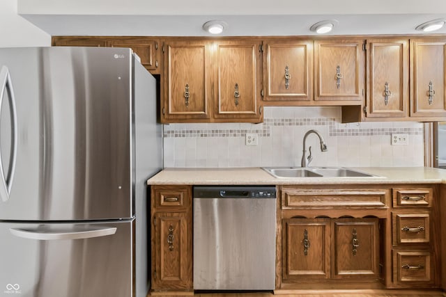 8439 Goldfinch Cir, Indianapolis, IN 46256 - kitchen featuring appliances with stainless steel finishes, brown cabinets, light countertops, and decorative backsplash