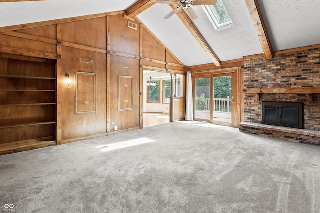 8439 Goldfinch Cir, Indianapolis, IN 46256 - unfurnished living room with wooden walls, a skylight, ceiling fan, a brick fireplace, and carpet flooring