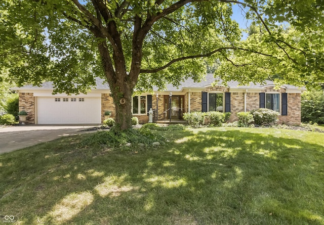 8439 Goldfinch Cir, Indianapolis, IN 46256 - obstructed view of property with brick siding, driveway, a garage, and a front lawn