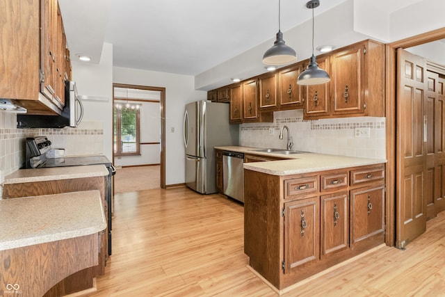 8439 Goldfinch Cir, Indianapolis, IN 46256 - kitchen featuring appliances with stainless steel finishes, brown cabinetry, and light wood-style floors