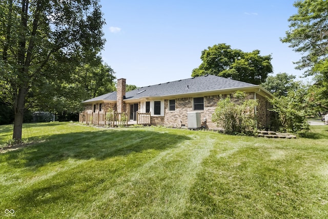8439 Goldfinch Cir, Indianapolis, IN 46256 - rear view of house featuring a chimney, a lawn, brick siding, and roof with shingles