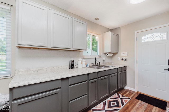 2824 E 150 S, Tipton, IN 46072 - kitchen featuring gray cabinetry, wood finished floors, pendant lighting, and light stone counters