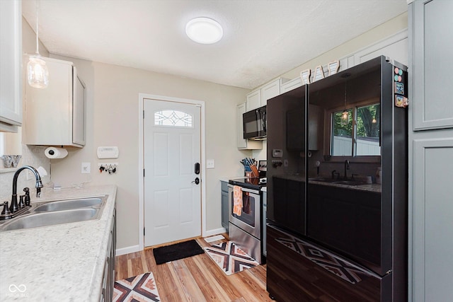 2824 E 150 S, Tipton, IN 46072 - kitchen with black appliances, light wood-style flooring, and light countertops