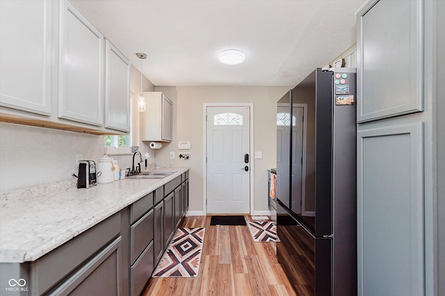 2824 E 150 S, Tipton, IN 46072 - kitchen featuring freestanding refrigerator, light wood-style flooring, hanging light fixtures, and gray cabinetry