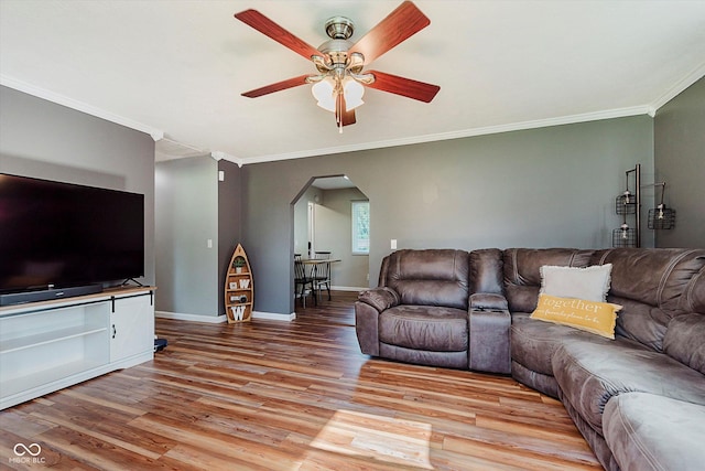 2824 E 150 S, Tipton, IN 46072 - living area featuring arched walkways, a ceiling fan, crown molding, and light wood-style flooring