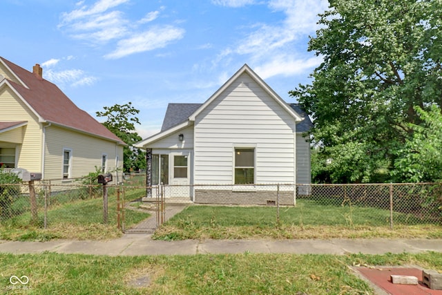 2400 Walnut St, Anderson, IN 46016 - back of house with a gate, a fenced front yard, and brick siding