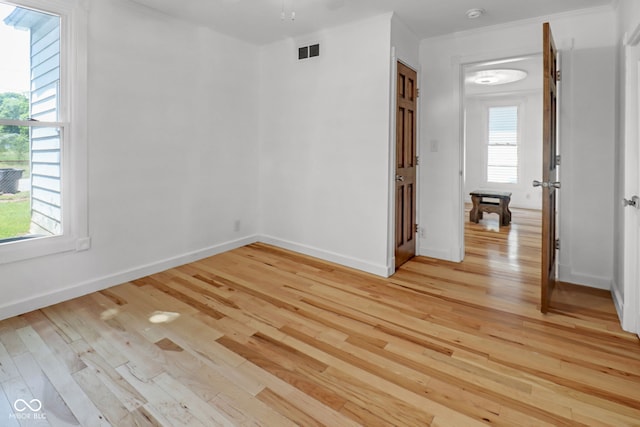 2400 Walnut St, Anderson, IN 46016 - spare room featuring light wood-style floors, healthy amount of natural light, and a smoke detector