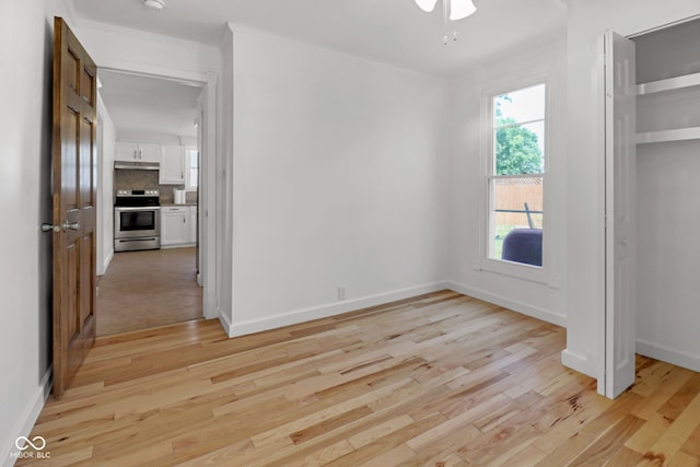 2400 Walnut St, Anderson, IN 46016 - unfurnished bedroom featuring light wood finished floors, crown molding, and a closet