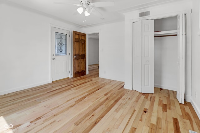 2400 Walnut St, Anderson, IN 46016 - unfurnished bedroom featuring light wood-style flooring, a ceiling fan, and a closet