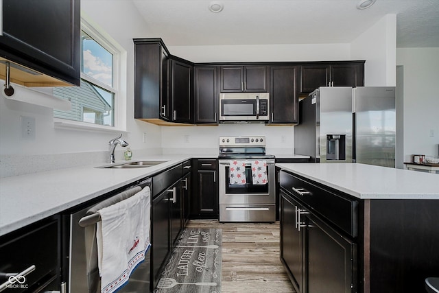 1461 Bigleaf Dr, Sheridan, IN 46069 - kitchen featuring appliances with stainless steel finishes, light wood finished floors, light countertops, and a center island