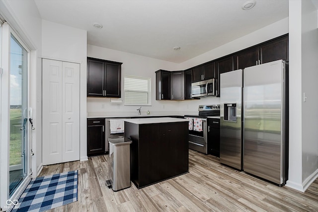 1461 Bigleaf Dr, Sheridan, IN 46069 - kitchen featuring appliances with stainless steel finishes, light wood-type flooring, light countertops, and a center island