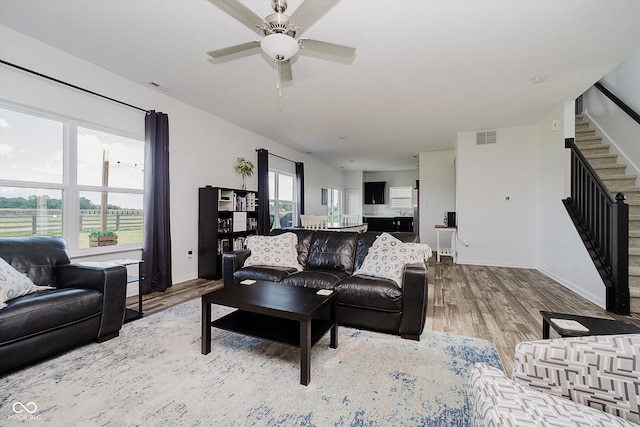 1461 Bigleaf Dr, Sheridan, IN 46069 - living room with stairway, wood finished floors, and a ceiling fan