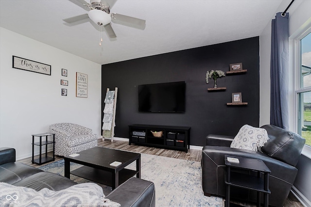 1461 Bigleaf Dr, Sheridan, IN 46069 - living area with an accent wall, plenty of natural light, wood finished floors, and a ceiling fan