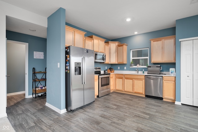 77 Winding Brook Way, Pendleton, IN 46064 - kitchen featuring appliances with stainless steel finishes, light brown cabinetry, wood finished floors, recessed lighting, and light countertops