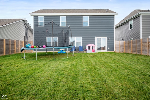 77 Winding Brook Way, Pendleton, IN 46064 - rear view of property featuring a trampoline and a fenced backyard