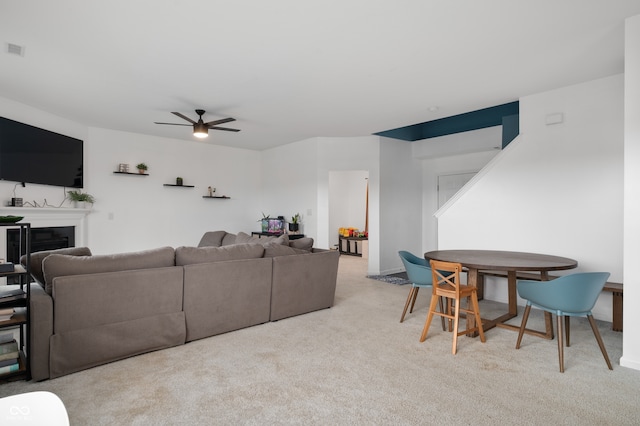 77 Winding Brook Way, Pendleton, IN 46064 - carpeted living room featuring a ceiling fan and a glass covered fireplace