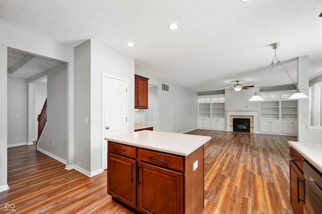 8578 Nolan Dr, Fishers, IN 46038 - kitchen with a ceiling fan, light wood finished floors, light countertops, a fireplace, and stainless steel dishwasher