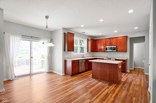 8578 Nolan Dr, Fishers, IN 46038 - kitchen featuring appliances with stainless steel finishes, light countertops, light wood-style floors, recessed lighting, and a kitchen island