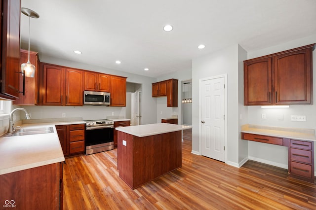 8578 Nolan Dr, Fishers, IN 46038 - kitchen with appliances with stainless steel finishes, light wood-type flooring, recessed lighting, a kitchen island, and light countertops