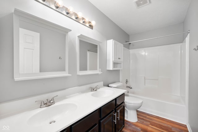 8578 Nolan Dr, Fishers, IN 46038 - full bath featuring double vanity, wood finished floors,  shower combination, and a textured ceiling