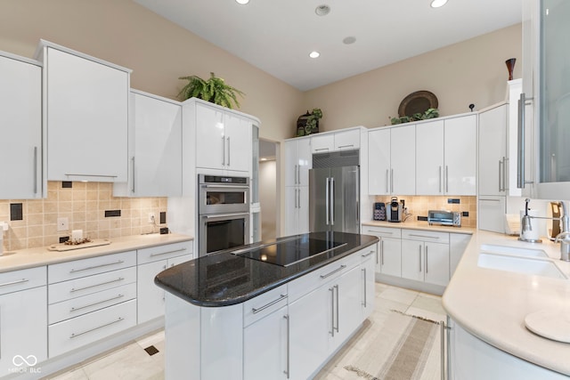 8164 Dean Rd, Indianapolis, IN 46240 - kitchen featuring appliances with stainless steel finishes, tasteful backsplash, a center island, light tile patterned flooring, and white cabinets