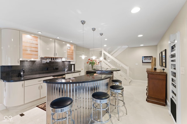 8164 Dean Rd, Indianapolis, IN 46240 - kitchen with a breakfast bar area, a center island, tasteful backsplash, recessed lighting, and hanging light fixtures