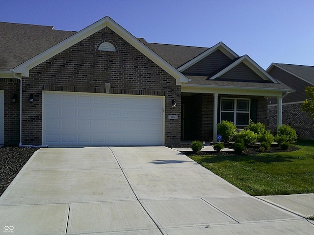 8804 Faulkner Dr, Indianapolis, IN 46239 - view of front of house with brick siding, an attached garage, driveway, a front yard, and a shingled roof