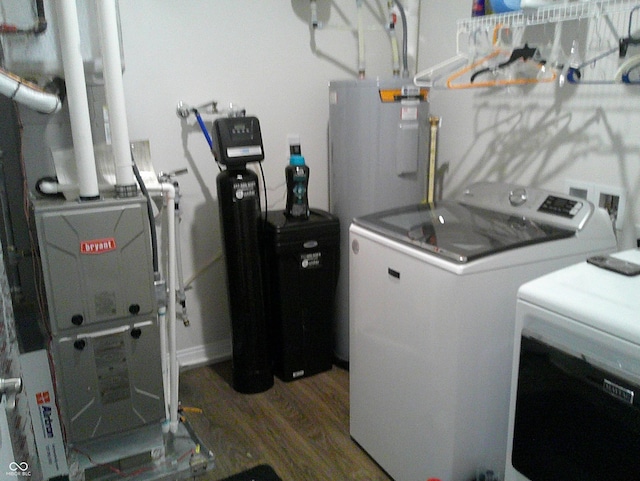 8804 Faulkner Dr, Indianapolis, IN 46239 - washroom with washing machine and clothes dryer, wood finished floors, electric water heater, and heating unit