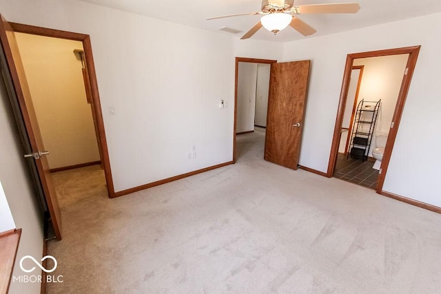 3948 S Woodfield Dr, New Palestine, IN 46163 - unfurnished bedroom with carpet flooring, connected bathroom, and a ceiling fan