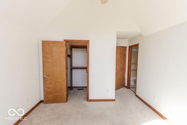 3948 S Woodfield Dr, New Palestine, IN 46163 - unfurnished bedroom with carpet, vaulted ceiling, ensuite bath, and a walk in closet