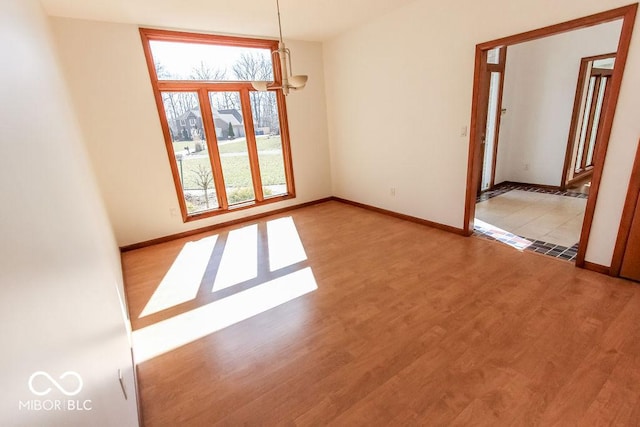 3948 S Woodfield Dr, New Palestine, IN 46163 - spare room featuring a chandelier and wood finished floors