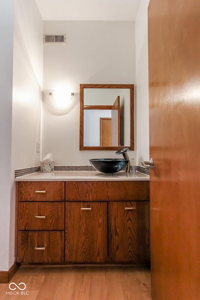 3948 S Woodfield Dr, New Palestine, IN 46163 - bathroom featuring wood finished floors and vanity