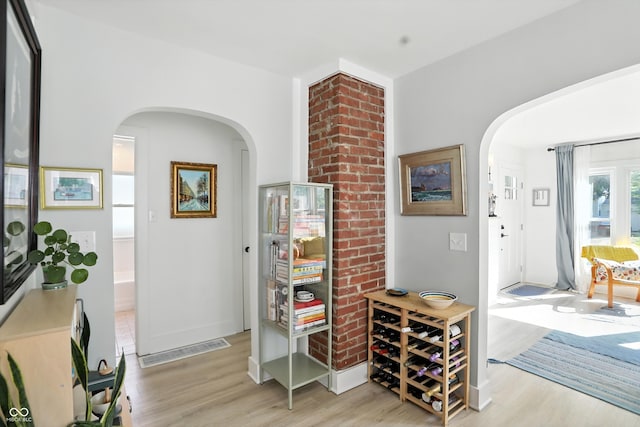 5312 Norwaldo Ave, Indianapolis, IN 46220 - corridor featuring arched walkways and wood finished floors