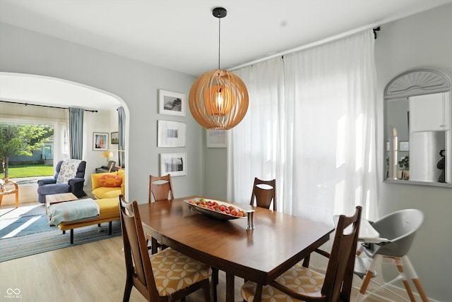 5312 Norwaldo Ave, Indianapolis, IN 46220 - dining space with arched walkways and light wood-style flooring