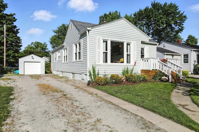 5312 Norwaldo Ave, Indianapolis, IN 46220 - bungalow-style home with dirt driveway, an outbuilding, a garage, roof with shingles, and a front yard