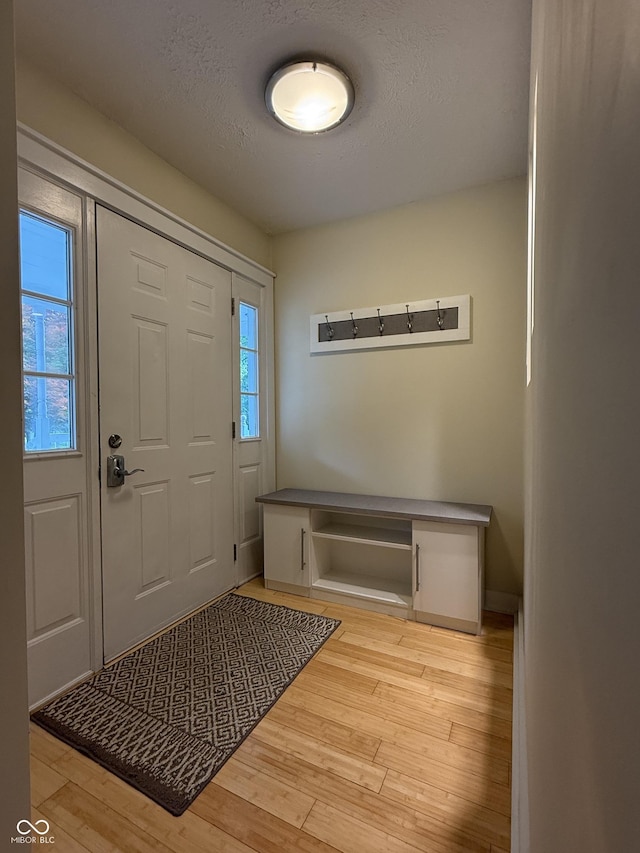 1738 E 71st St, Indianapolis, IN 46220 - foyer with light wood-style floors and a textured ceiling