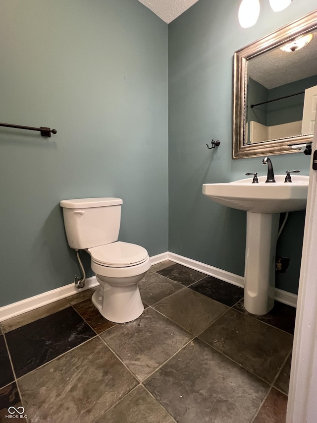 1738 E 71st St, Indianapolis, IN 46220 - bathroom featuring toilet and a textured ceiling