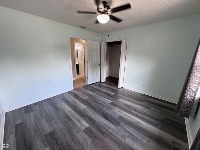 1206 Brownswood Dr, Brownsburg, IN 46112 - unfurnished bedroom featuring a textured ceiling, dark wood-type flooring, a closet, and a ceiling fan