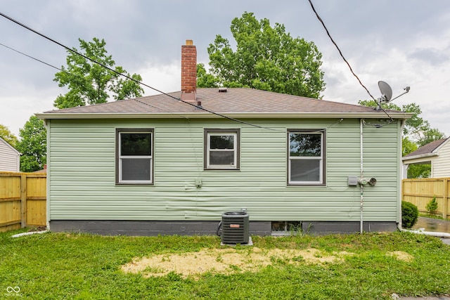 1710 N Irvington Ave, Indianapolis, IN 46218 - back of house with a chimney and a shingled roof