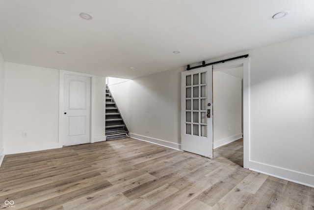 1710 N Irvington Ave, Indianapolis, IN 46218 - finished below grade area featuring stairway, a barn door, and wood finished floors