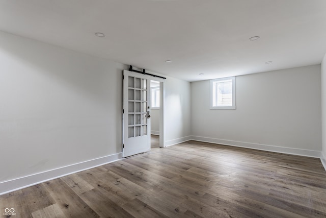 1710 N Irvington Ave, Indianapolis, IN 46218 - unfurnished room featuring a barn door and wood finished floors