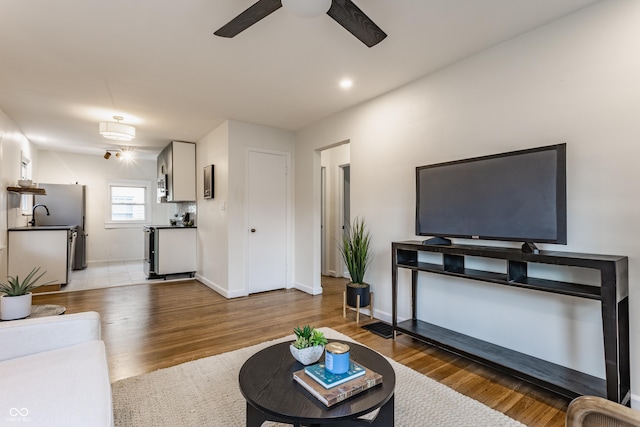 1710 N Irvington Ave, Indianapolis, IN 46218 - living room featuring a ceiling fan and wood finished floors