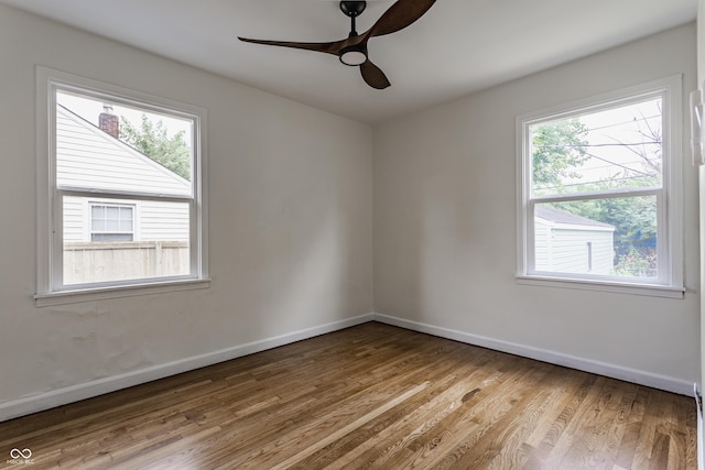 1710 N Irvington Ave, Indianapolis, IN 46218 - empty room with wood finished floors and ceiling fan