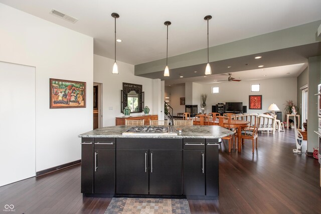 1036 Jackson St, Columbus, IN 47201 - kitchen with dark wood finished floors, ceiling fan, stainless steel gas stovetop, dark cabinetry, and open floor plan